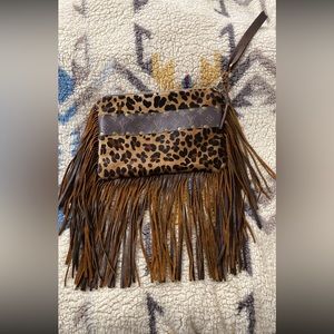 Cowhide and Fringe Wristlet with LV details.